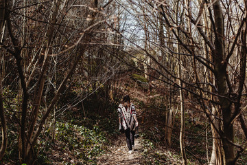 stylish hipster woman walking  with analog photo camera in woods