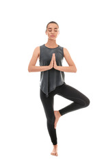 Obraz premium Young woman practicing yoga on white background