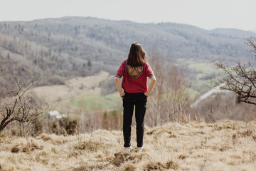 Fototapeta premium happy stylish hipster woman standing on top of hill mountain, cheerful moment of happiness