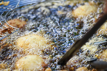 Thailand country local desserts using the dough balls round frying pan in a tricky market