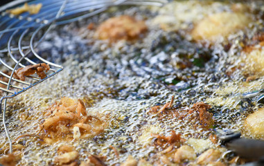 Thailand country local desserts using the dough balls round frying pan in a tricky market