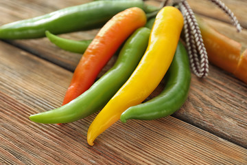 Fresh chili peppers on wooden background