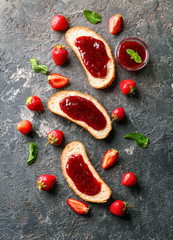 Toasts with strawberry jam on dark background