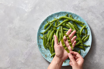 Pear sticks on blue ceramic plate on gray concrete table stick of pea, which cleans or opens the...