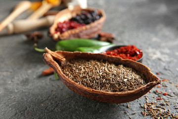 Cocoa pod with cumin seeds on grunge background