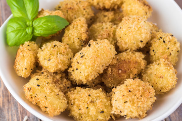 Baked crispy potato gnocchi with bread crumbs.