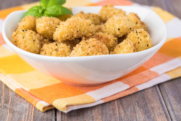 Baked crispy potato gnocchi with bread crumbs.