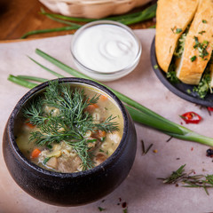Delicious mushroom soup in a pot with garlic bread.