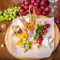 Cheese plate on wooden board.