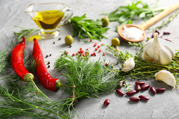 Fresh herbs with spices on grey textured background
