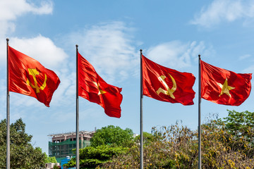 Four Vietnam flags waving in the wind in Hanoi, Vietnam