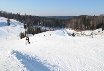 Fototapeta na wymiar Ski slope, people skiing down the hill, mountains view. Cesis. Latvia