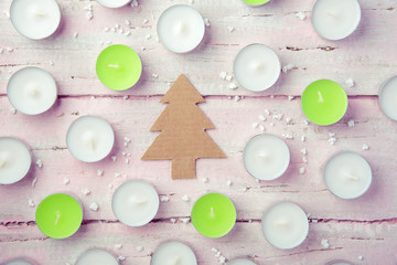 A few flat white candles on a beautiful wooden table