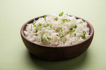 Coriander or cilantro Basmati Rice, served in a ceramic or terracotta bowl. It's a popular Indian OR Chinese recipe. Selective focus