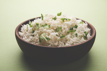 Coriander or cilantro Basmati Rice, served in a ceramic or terracotta bowl. It's a popular Indian OR Chinese recipe. Selective focus