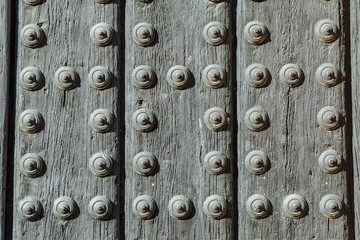 background of old wooden door with iron rivets.