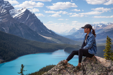 Young girl enjoying the beautiful Canadian Rockies Landscape view during a vibrant sunny summer day. Taken in Peyto Lake, Banff National Park, Alberta, Canada.