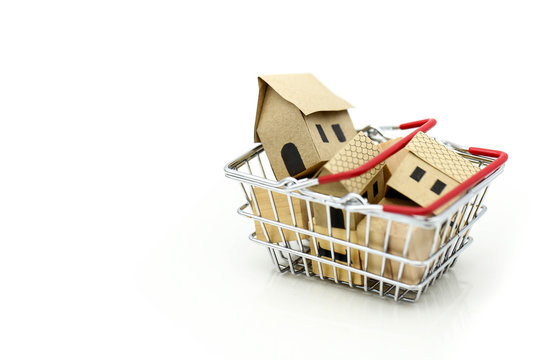 Wooden house in a shopping basket,Property investment and house mortgage financial concept. buying, renting and selling apartments. real estate