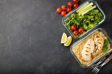 Healthy meal prep containers with quinoa, chicken breast and green salad overhead shot with copy...