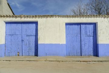 old wooden doors of indigo color in the town of El Toboso in the province of Toledo, Spain.