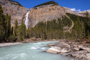 Takakkaw Falls in Yoho National Park during a vibrant sunny summer day. Located in British Columbia, Canada.