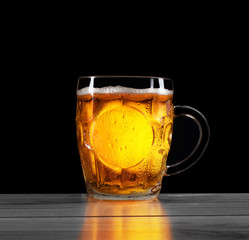 a pint of beer on a black background