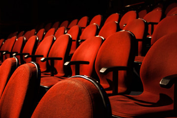 Empty red velvet theatre seat wallpaper background. No people.