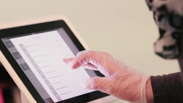 Payment transaction with credit card and touch screen in restaurant.