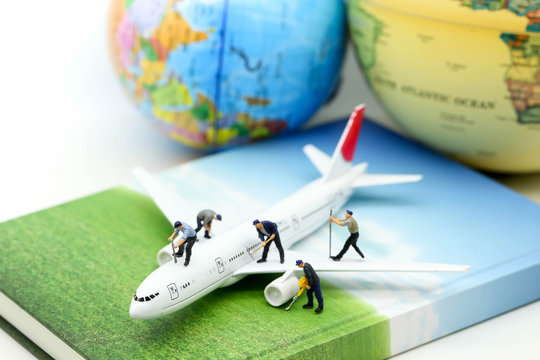 Miniature people : worker clean air plane using for business trip concept.