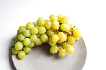 Ripe grape fruit isolated on grey concrete plate close up