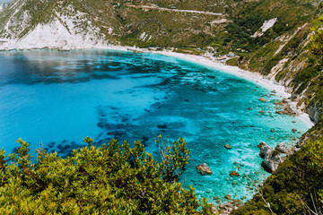 Petani beach in summer, Kefalonia island, Greece. View to Petani bay with transparent and crystal clear blue azure mediterranean sea water in beautiful beach lagoon, Kefalonia island, Greece