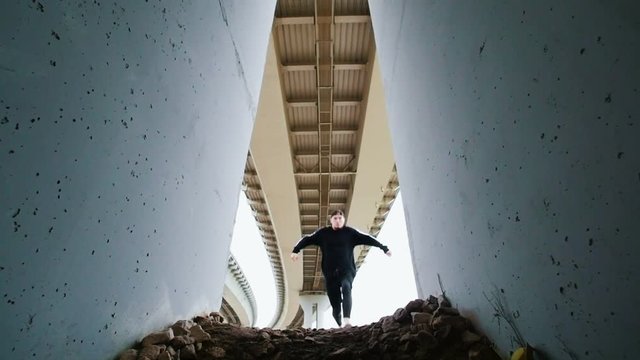 Parkour, guy doing flips, bottom view
