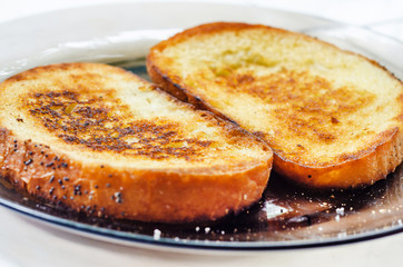 Toasts, two pieces of fried bread on butter