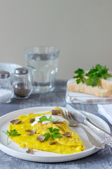 Omelette with truffle and parsley, served with sour cream, bread and a glass of fresh water.