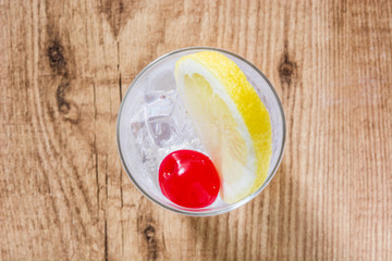 Classic Tom Collins cocktail on wooden table. Top view