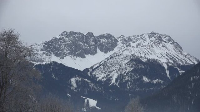 Long range shot of the Grubigstein mountain range in Austria with some of its skiing slopes in winter