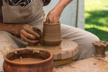 Fototapeta na wymiar Potter working with clay, making pot
