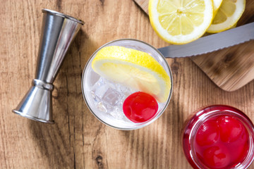 Classic Tom Collins cocktail on wooden table. Top view