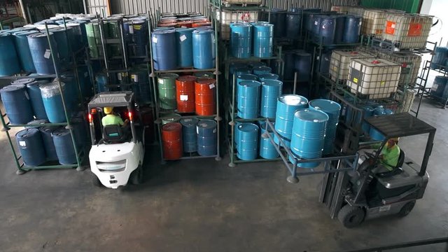 Fork-Lift In Factory Taking Barrels From Shelf - High Shot 