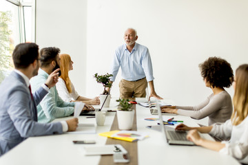 Senior boss holds a meeting for younger colleagues