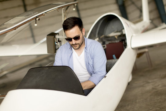 Young pilot checking ultralight airplane before flight