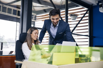 Business couple working together on project at modern startup office