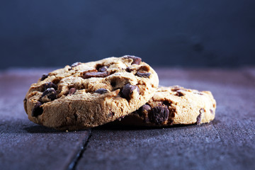 Chocolate cookies on table. Chocolate chip cookies shot with chocolate