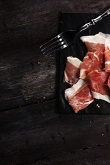 Italian prosciutto crudo or jamon with rosemary. Raw ham