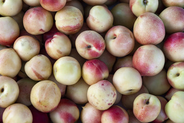 Pile of fresh orange and yellow apples top view close up.