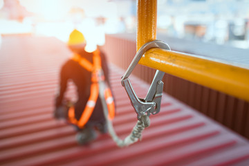 Construction worker wearing safety harness and safety line - obrazy, fototapety, plakaty