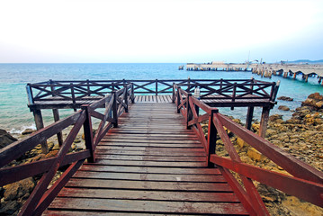 Fototapeta premium The wood bridge beside the sea, the walk way for sight seeing the seascape