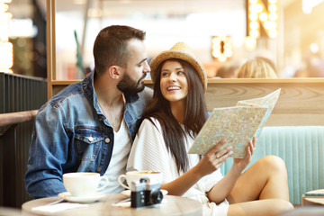 Happy tourists having a break in cafe