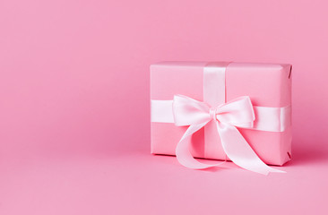 Gift or present box on pink background.