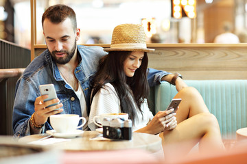 Happy tourists having a break in cafe